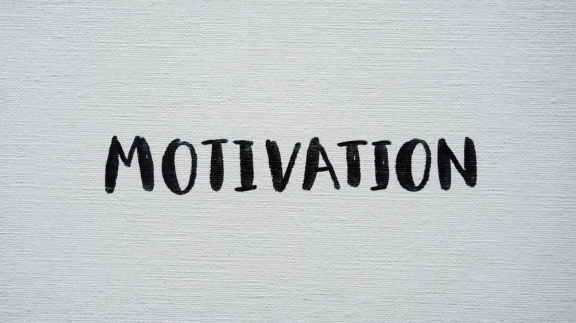Inspirational word 'Motivation' in black on a white textured canvas background.